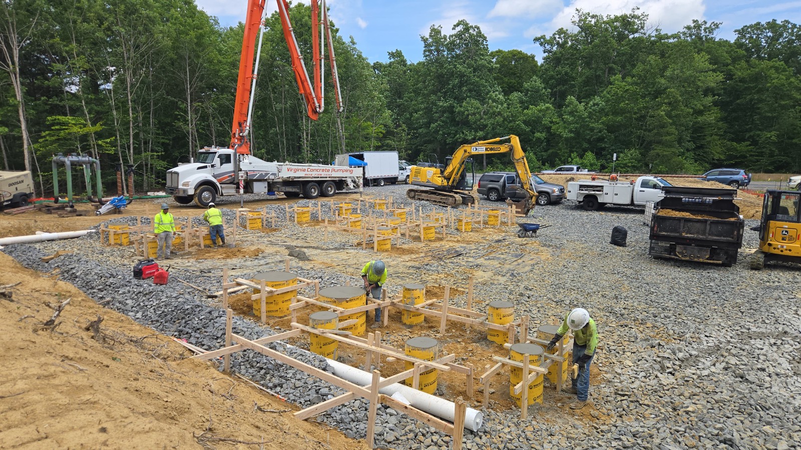 Concrete pump truck and rebar footing forms staged on an active Oxen Civil construction site near Lynchburg, VA
