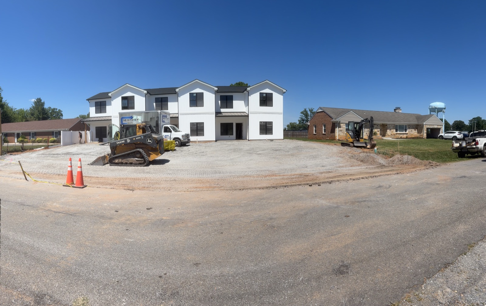 Lote comercial recién nivelado listo para un edificio nuevo, con bulldozer en el sitio